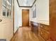 Inviting hallway featuring hardwood floors and a convenient built-in desk area at 120 Rolling Brook Trl, Fayetteville, GA 30215