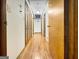 Hallway featuring hardwood floors with multiple closets and doors at 120 Rolling Brook Trl, Fayetteville, GA 30215
