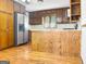 Kitchen with wood cabinets, stainless steel appliances, and hardwood floors at 120 Rolling Brook Trl, Fayetteville, GA 30215