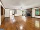 Open living room features hardwood floors, a brick fireplace, and abundant natural light at 120 Rolling Brook Trl, Fayetteville, GA 30215
