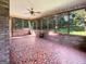 Screened porch with brick flooring, ceiling fan, and views of the backyard at 120 Rolling Brook Trl, Fayetteville, GA 30215