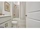 Bright bathroom with a shower-tub combo, neutral tile surround, and a modern vanity and sink at 82 Airmont Dr, Sharpsburg, GA 30277