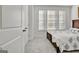 Comfortable bedroom with a full-size bed, plush carpet, and bright natural light from the multiple windows at 82 Airmont Dr, Sharpsburg, GA 30277