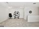 A bonus room featuring neutral carpet, white walls, a decorative shelf, and an office chair at 82 Airmont Dr, Sharpsburg, GA 30277