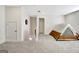View of a spacious bonus room with neutral carpet and white walls, staging with a tent at 82 Airmont Dr, Sharpsburg, GA 30277