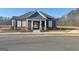 Attractive community clubhouse featuring a stylish blue exterior, complemented by manicured landscaping and inviting entrance at 82 Airmont Dr, Sharpsburg, GA 30277