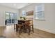 Inviting dining area with a wooden table, stools, and natural light at 82 Airmont Dr, Sharpsburg, GA 30277