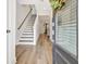 Bright and welcoming foyer featuring hardwood floors, staircase with modern railing, and open layout at 82 Airmont Dr, Sharpsburg, GA 30277