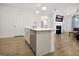 Open kitchen with an island, stainless steel appliances, and pendant lighting at 82 Airmont Dr, Sharpsburg, GA 30277