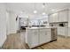 Modern kitchen featuring stainless steel appliances, white cabinetry, a kitchen island, and light wood floors at 82 Airmont Dr, Sharpsburg, GA 30277
