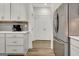 Bright kitchen with stainless steel refrigerator and white cabinets at 82 Airmont Dr, Sharpsburg, GA 30277