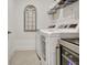 This laundry room offers modern appliances, decorative shelving, and space for convenience at 82 Airmont Dr, Sharpsburg, GA 30277