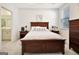 This bedroom features a wooden bedframe, neutral walls, carpet, and lots of natural light at 82 Airmont Dr, Sharpsburg, GA 30277