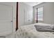 Bright main bedroom featuring a four-poster bed, neutral carpet, and well-lit with natural light streaming through the window at 82 Airmont Dr, Sharpsburg, GA 30277