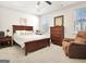 This bedroom features a wooden bedframe, neutral walls, carpet, and lots of natural light at 82 Airmont Dr, Sharpsburg, GA 30277
