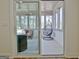 A sliding glass door opens onto a sunroom with a hanging chair and seating area at 82 Airmont Dr, Sharpsburg, GA 30277
