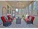 The back porch features a ceiling fan, stylish seating, decor, and lots of natural light at 82 Airmont Dr, Sharpsburg, GA 30277