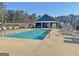 Community pool with lounge chairs and clubhouse providing residents a resort-like experience at 82 Airmont Dr, Sharpsburg, GA 30277