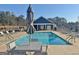 Inviting community pool area with lounge chairs and a modern clubhouse, perfect for relaxation and social gatherings at 82 Airmont Dr, Sharpsburg, GA 30277