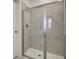 The bathroom features a tiled walk-in shower with glass door and modern shower head at 82 Airmont Dr, Sharpsburg, GA 30277