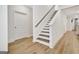 Well-lit staircase with hardwood treads and white risers, complemented by light wood floors and neutral walls at 82 Airmont Dr, Sharpsburg, GA 30277