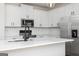 Bright kitchen showcasing white cabinetry, stainless steel appliances, and a sleek faucet over the island sink at 615 Cantrell Drive, Dallas, GA 30157