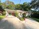 Ranch-style home with a carport, concrete driveway, and landscaped greenery at 2229 Sharon Way, Decatur, GA 30032