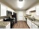 Kitchen featuring stainless steel appliances, granite counters, wood flooring, and white cabinetry at 2229 Sharon Way, Decatur, GA 30032