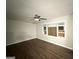 Open living room boasts modern ceiling fan, wood flooring, and a bright window at 2229 Sharon Way, Decatur, GA 30032