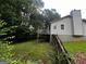 A lush backyard with a wooden fence and a raised deck, creating a serene outdoor space at 1504 Colt Ridge Se Ln, Mableton, GA 30126