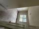 Bedroom with dirty carpet and natural light streaming through a large window at 1504 Colt Ridge Se Ln, Mableton, GA 30126