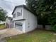 A view of the side of the house, with the attached garage, and stairs to the front entrance at 1504 Colt Ridge Se Ln, Mableton, GA 30126
