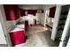Dated kitchen with red cabinets and laminate countertops, presenting an opportunity for a modern remodel at 1504 Colt Ridge Se Ln, Mableton, GA 30126
