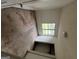 An upper-level landing with carpet and a window, offering a transition space between rooms at 1504 Colt Ridge Se Ln, Mableton, GA 30126