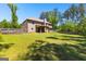 Spacious backyard with a covered patio, mature trees, and lush green grass at 105 Turnberry Trce, Sharpsburg, GA 30277