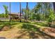 Beautiful backyard with a black metal fence, mature trees, bird bath, and a small garden at 105 Turnberry Trce, Sharpsburg, GA 30277