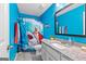 Bright bathroom with blue walls, fun shower curtain, and modern vanity with granite countertops at 105 Turnberry Trce, Sharpsburg, GA 30277
