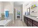 Spacious bathroom with double vanity, walk-in shower, tub, tile flooring, and ensuite bedroom at 105 Turnberry Trce, Sharpsburg, GA 30277