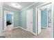 Bright bedroom features neutral carpet and doors that lead to other rooms, all illuminated by recessed lighting at 105 Turnberry Trce, Sharpsburg, GA 30277