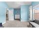Cozy blue bedroom featuring neutral carpet, built-in shelves, and bright natural light at 105 Turnberry Trce, Sharpsburg, GA 30277