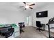 This room has a ceiling fan, TV, lots of space, and a door leading to the next room at 105 Turnberry Trce, Sharpsburg, GA 30277