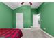 Green bedroom with carpet and doors, featuring vibrant green walls and neutral carpet flooring at 105 Turnberry Trce, Sharpsburg, GA 30277