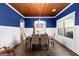 Elegant dining room with wood floors, a chandelier, and tasteful blue accent walls at 105 Turnberry Trce, Sharpsburg, GA 30277