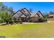 Charming home featuring a landscaped yard, stone accents, and a welcoming front entrance at 105 Turnberry Trce, Sharpsburg, GA 30277