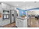 Kitchen with stainless steel appliances, granite countertops, kitchen island and open access to the living room at 105 Turnberry Trce, Sharpsburg, GA 30277