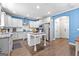 Open-concept kitchen with white cabinets, stainless steel appliances, and a central island at 105 Turnberry Trce, Sharpsburg, GA 30277