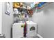 Functional laundry room with washer, dryer, wire shelving, and essential cleaning supplies at 105 Turnberry Trce, Sharpsburg, GA 30277