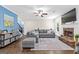 Spacious living room with cozy fireplace, plush seating, and hardwood floors at 105 Turnberry Trce, Sharpsburg, GA 30277