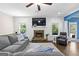 Relaxing living room with a cozy stone fireplace and comfortable seating at 105 Turnberry Trce, Sharpsburg, GA 30277