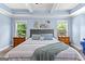 Main bedroom with a tray ceiling, ceiling fan, plush carpeting and two windows at 105 Turnberry Trce, Sharpsburg, GA 30277